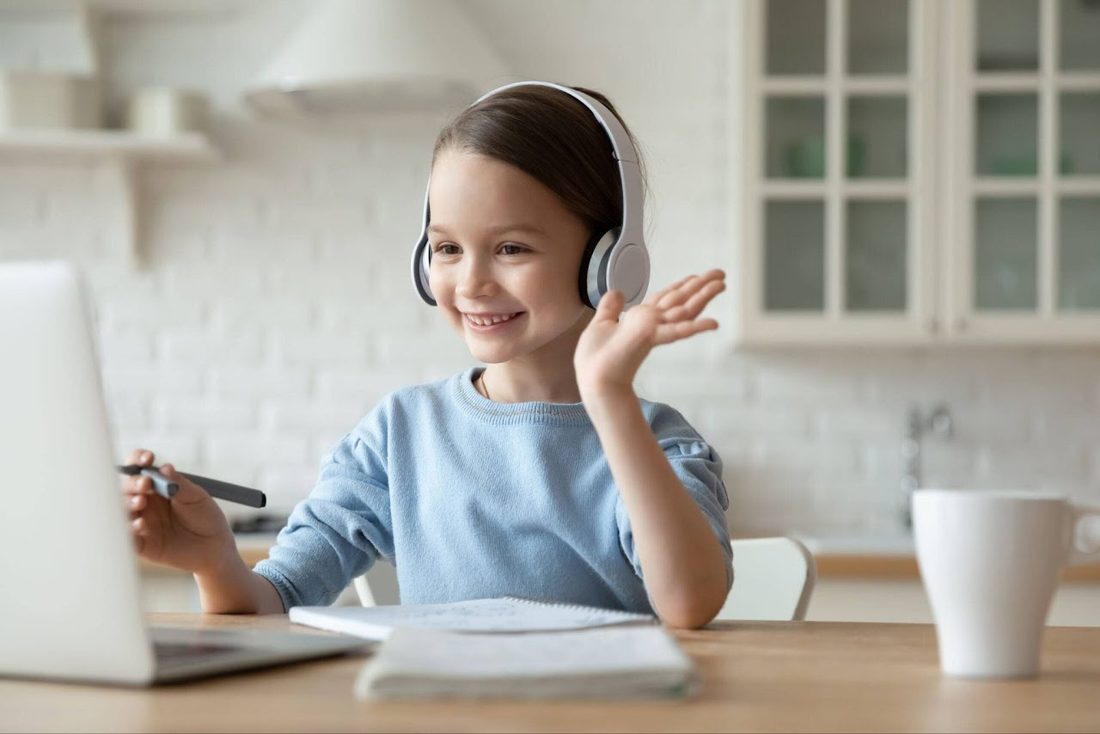 Smiling K–5 student in an online tutoring session